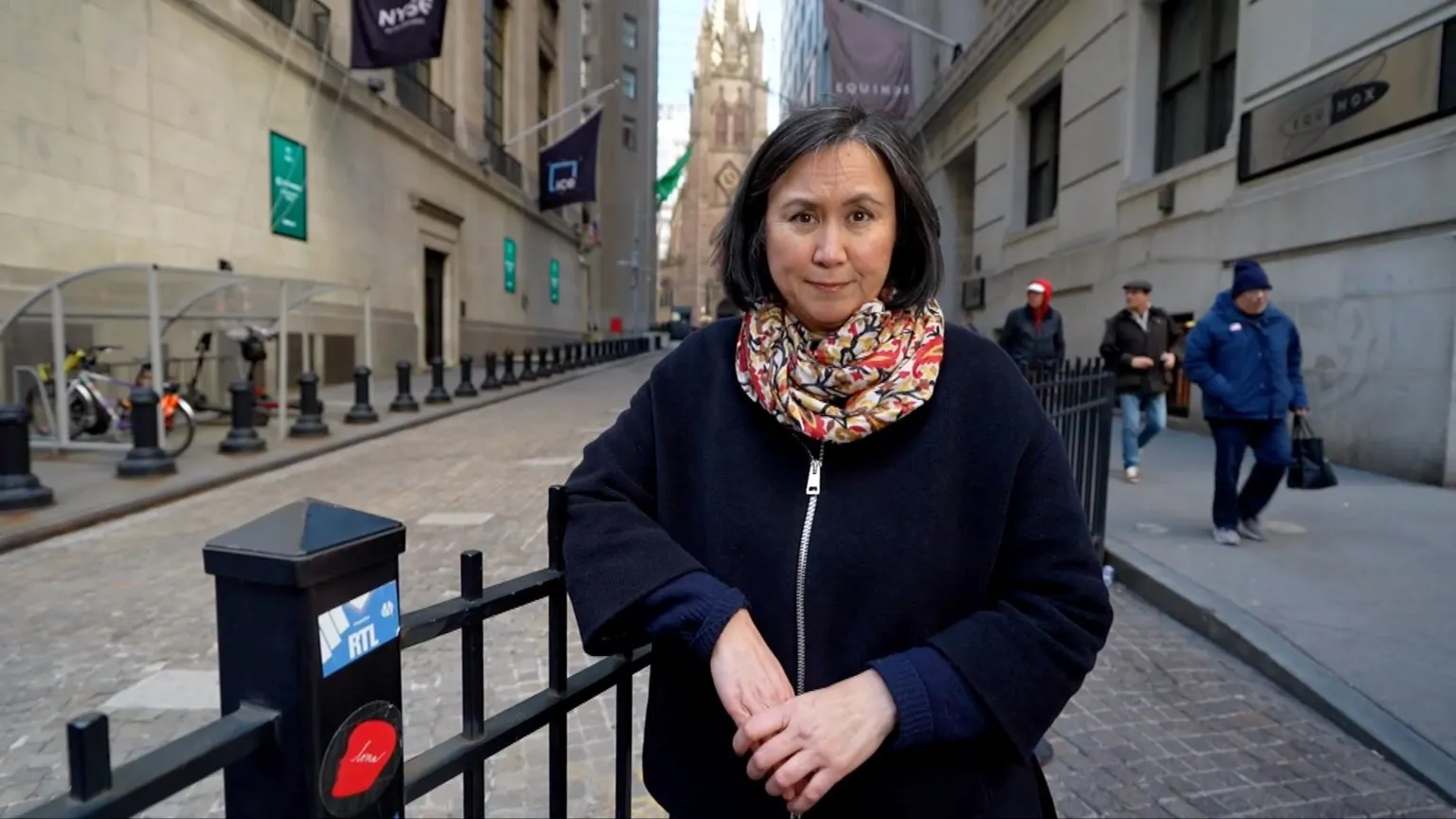 Michelle Fleury stands on the Wall Street.