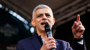 EPA Mayor of London Sadiq Khan speaks on stage. He is wearing a navy jacket and an open-necked white shirt.