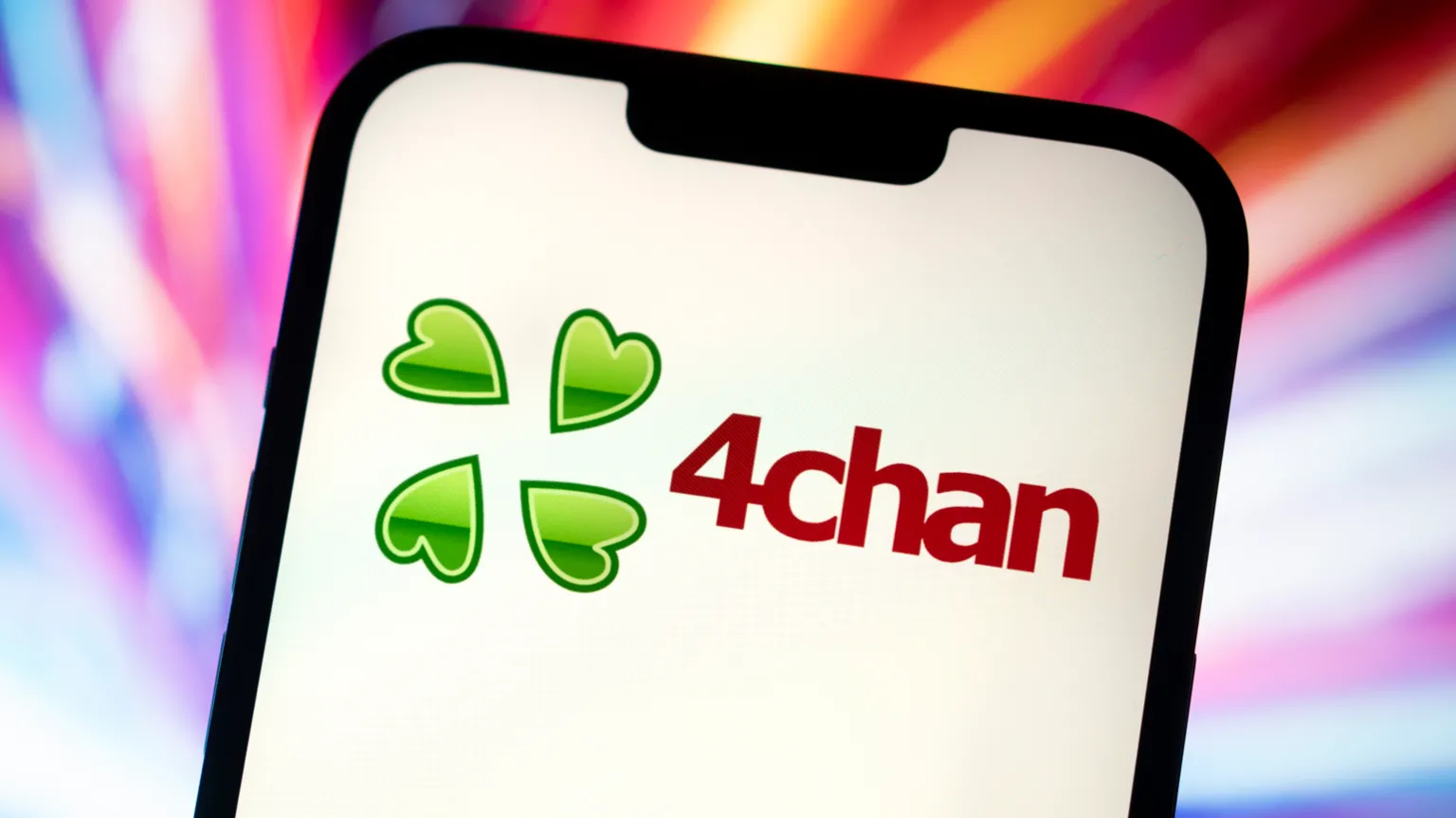 Getty Images The 4chan logo displayed on a phone screen. It is four concentric green hearts, similar to a four-leaf clover.