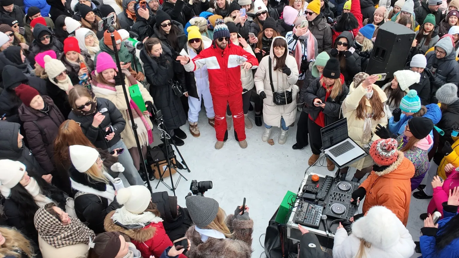 People in a circle with a DJ booth