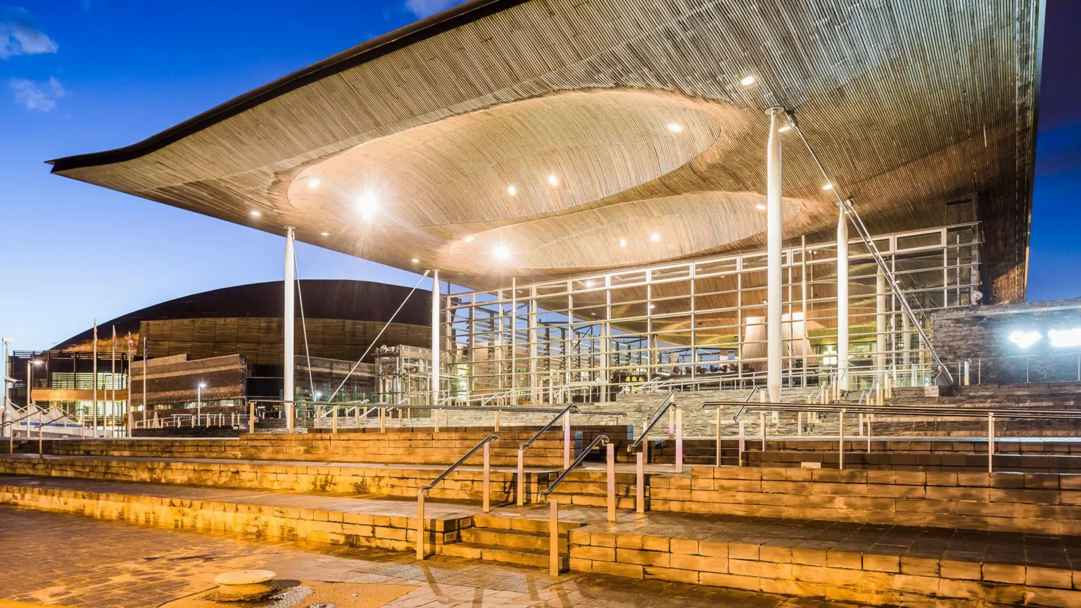 Getty Images A view of the Senedd building. Designed by architect Richard Rogers, the building’s sweeping roof, slate plinth, internal funnel and glass walls were created to rise out of Cardiff Bay and welcome visitors in.