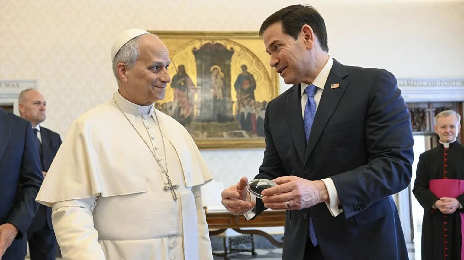 Marco Rubio shows off a glass american football model to Leo XIV