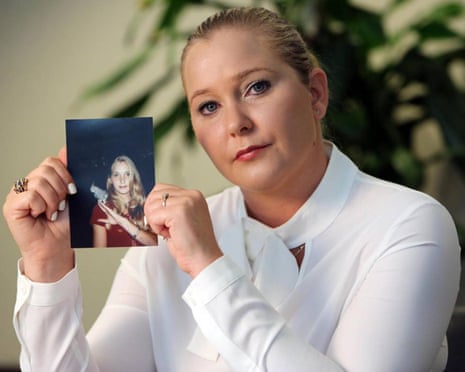 Virginia Giuffre holds up a photograph of herself as a teenager.