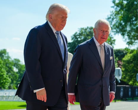 King Charles III walks with U.S. President Donald Trump on the South Lawn of the White House.