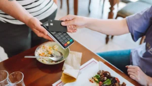 Getty Images Person paying for food in a restaurant using contactless card