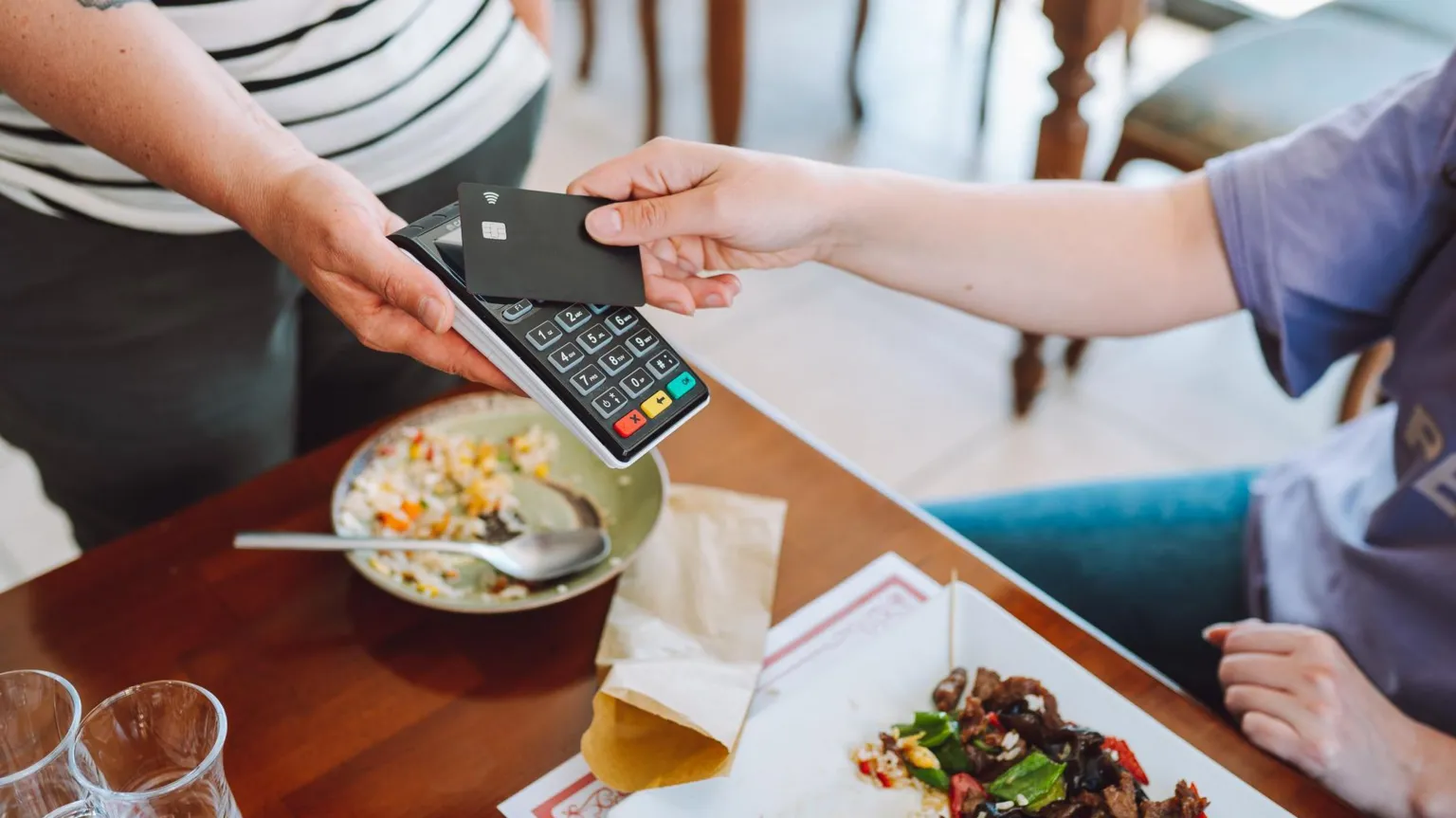 Getty Images Person paying for food in a restaurant using contactless card