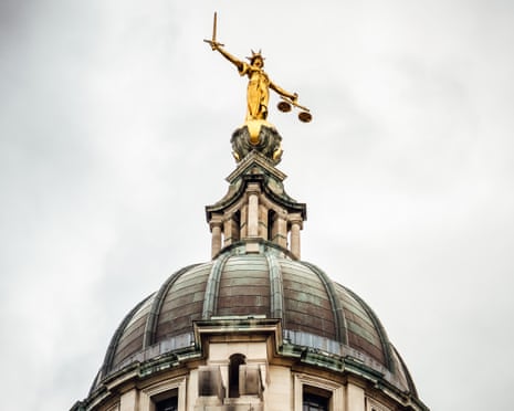 The golden Lady Justice statue holding a sword and scales stands atop the Old Bailey's dome