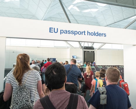 Travellers queue under an 'EU passport holders' sign at Stansted airport.