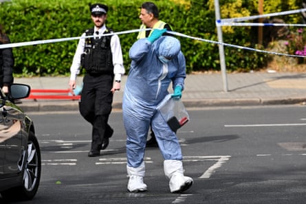 A forensic officer working at the scene of the stabbings in Golders Green, London.