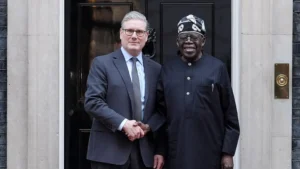 PA Media Prime Minister Sir Keir Starmer shakes hands with Nigerian President Bola Ahmed Tinubu outside the black door on 10 Downing Street.