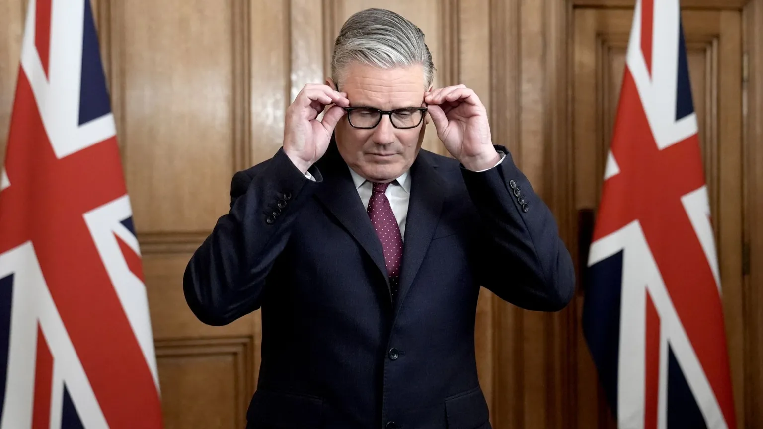 Prime Minister Sir Keir Starmer adjusts his glasses as he speaks in Downing Street, Westminster, London, in April 2026