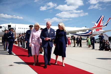 Britain’s King Charles III and Queen Camilla walk with US Protocol Chief Monica Crowley as they arrive at Joint Base Andrews, Maryland.