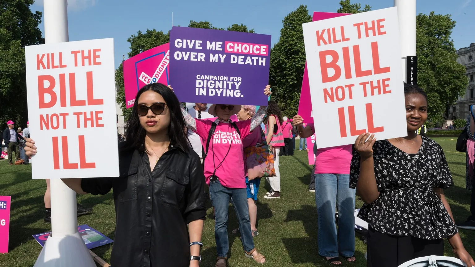 Getty Images People holding signs saying 'kill the bill not the ill' and 'give me choice over my death' stand protesting outdoors in Parliament Square in early June 2025.