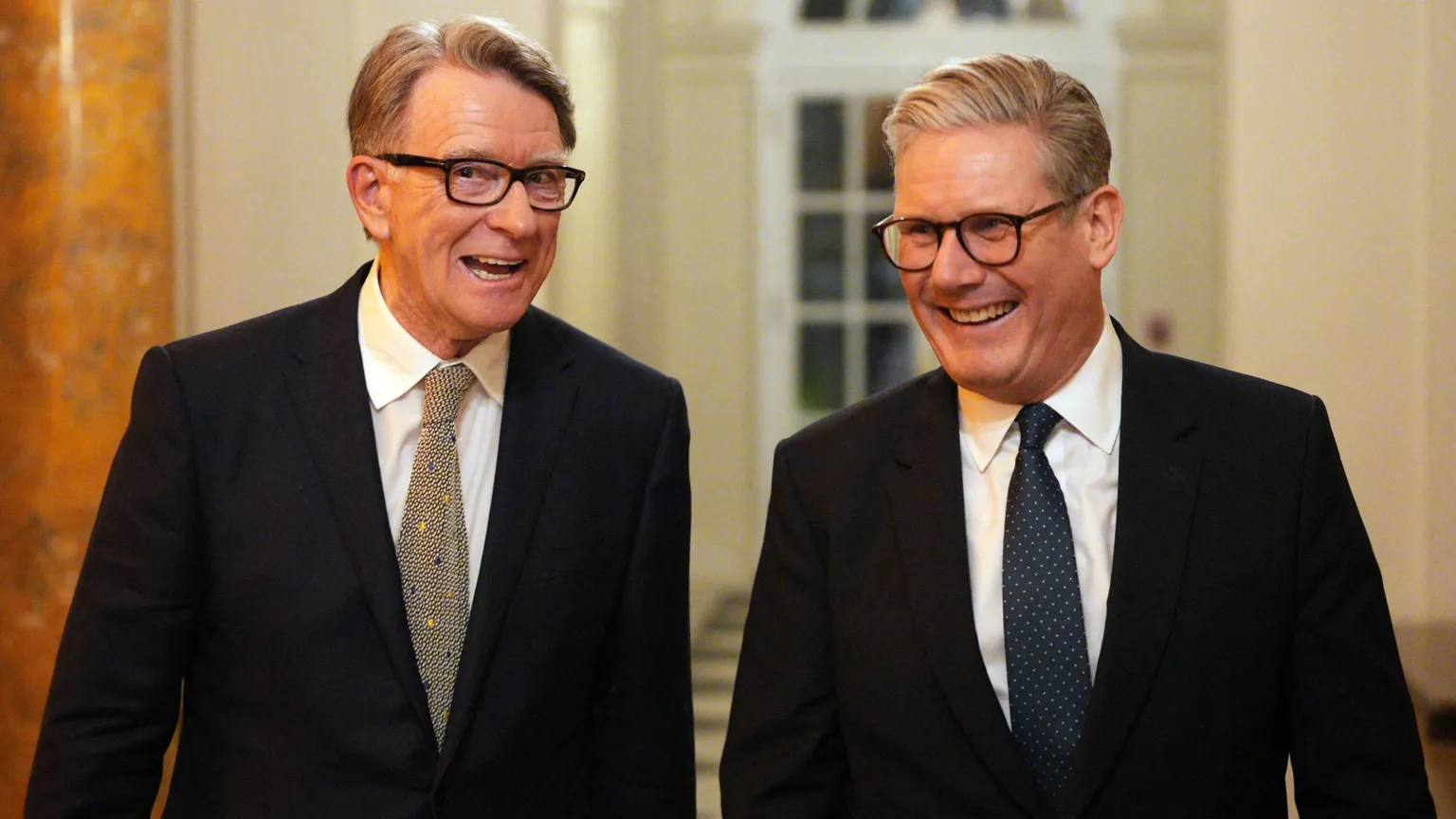 AFP via Getty Images Lord Mandelson stands next to Keir Starmer. Both are wearing suits.