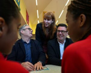 Keir Starmer with Angela Rayner and Andy Burnham with two children in the foreground of the picture