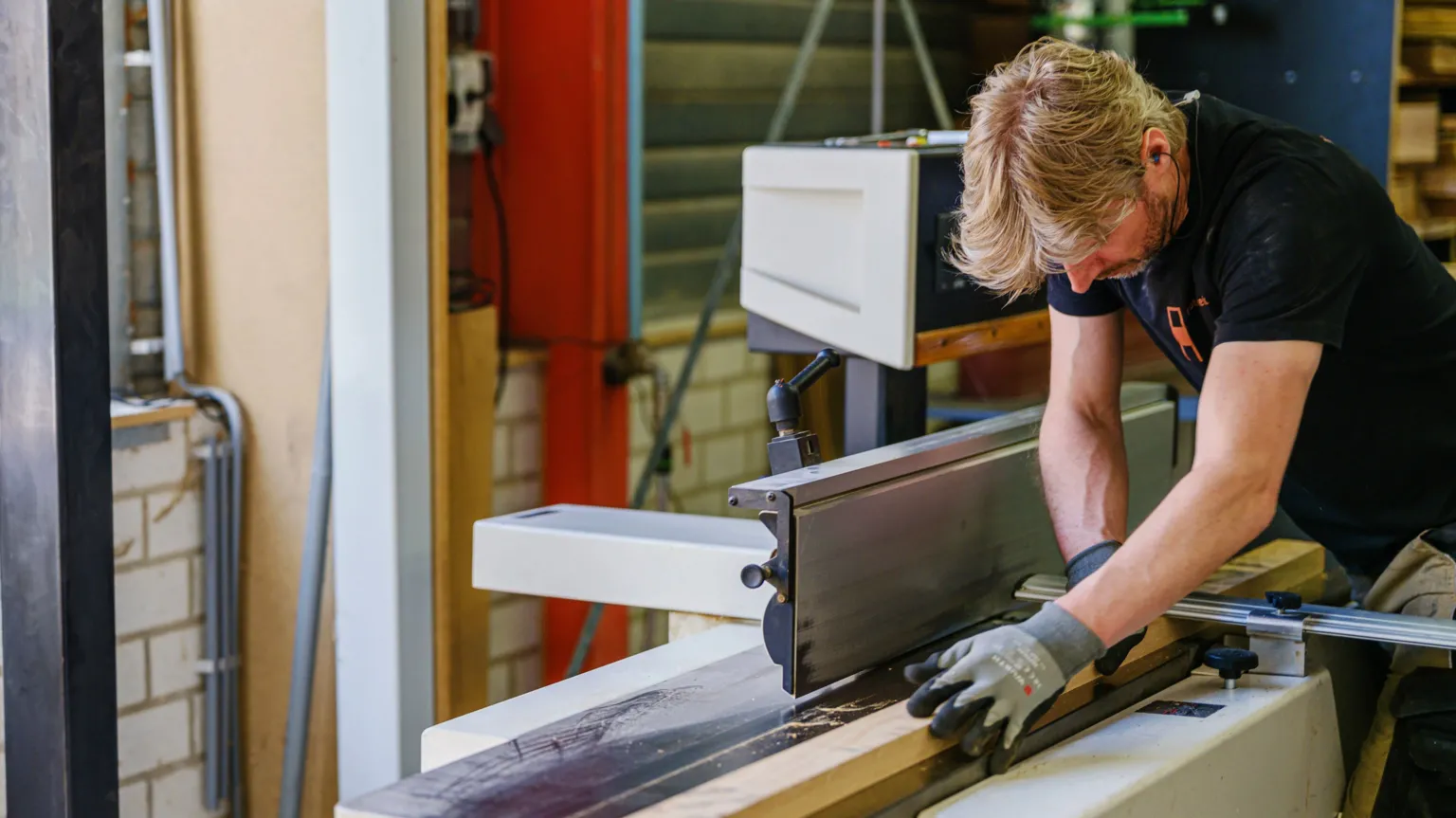 Marlies Wessels A woodworking cuts wood on a large table saw
