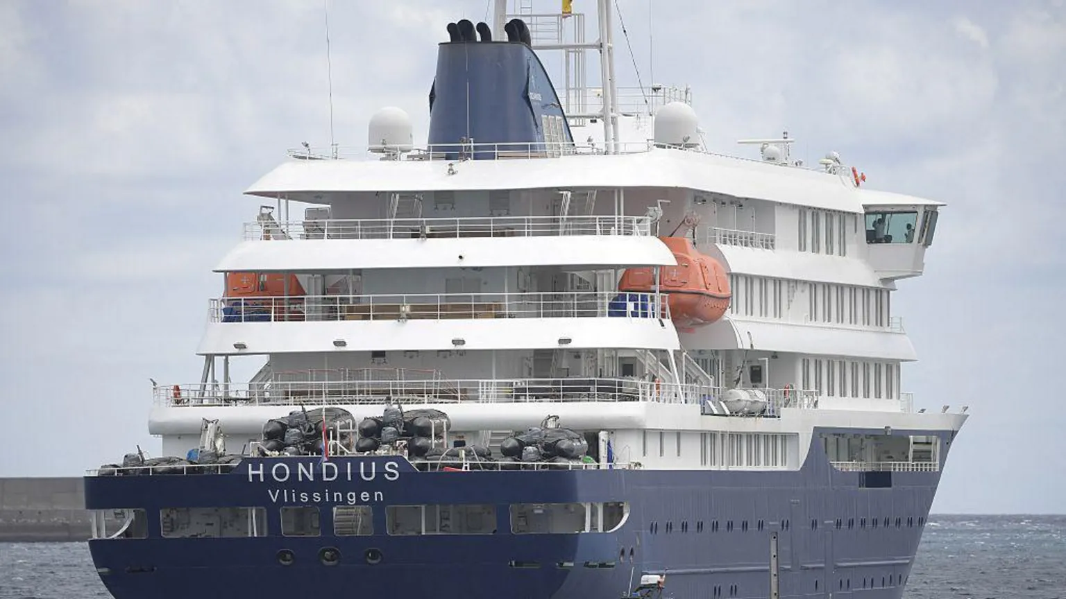 Large blue and white cruise ship with the words Hondius Vlissingen on it
