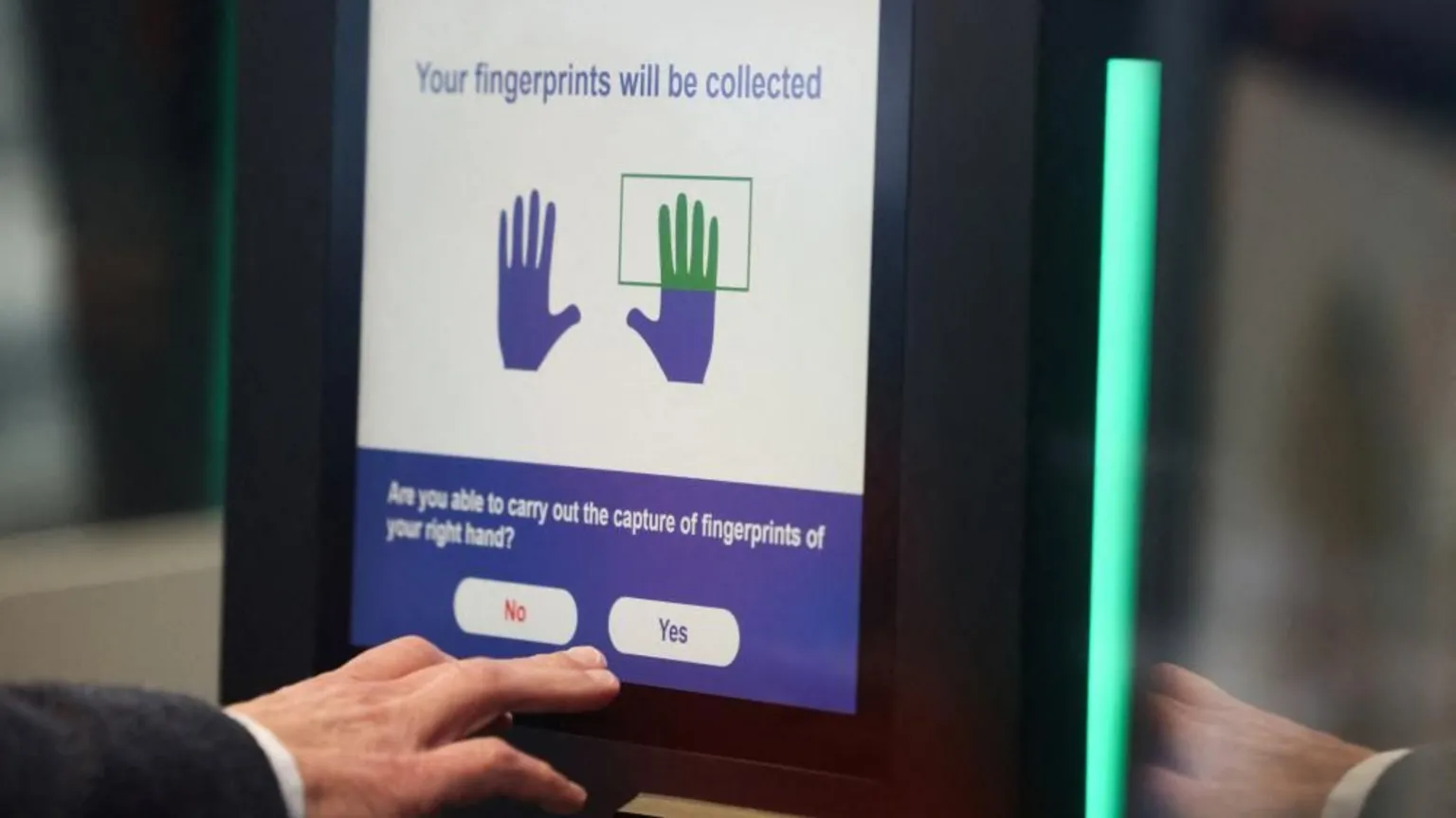 Reuters A man operates an automated EES kiosk during a demonstration of the European Union's Entry/Exit System (EES).