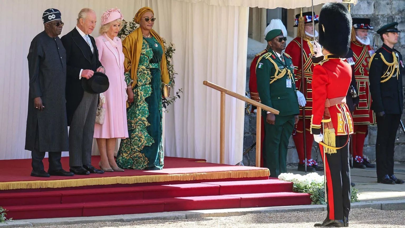 Getty Images King Charles, President Tinubu, Queen Camilla and First Lady  Oluremi Tinubu with other uniformed figures outside Windsor Castle