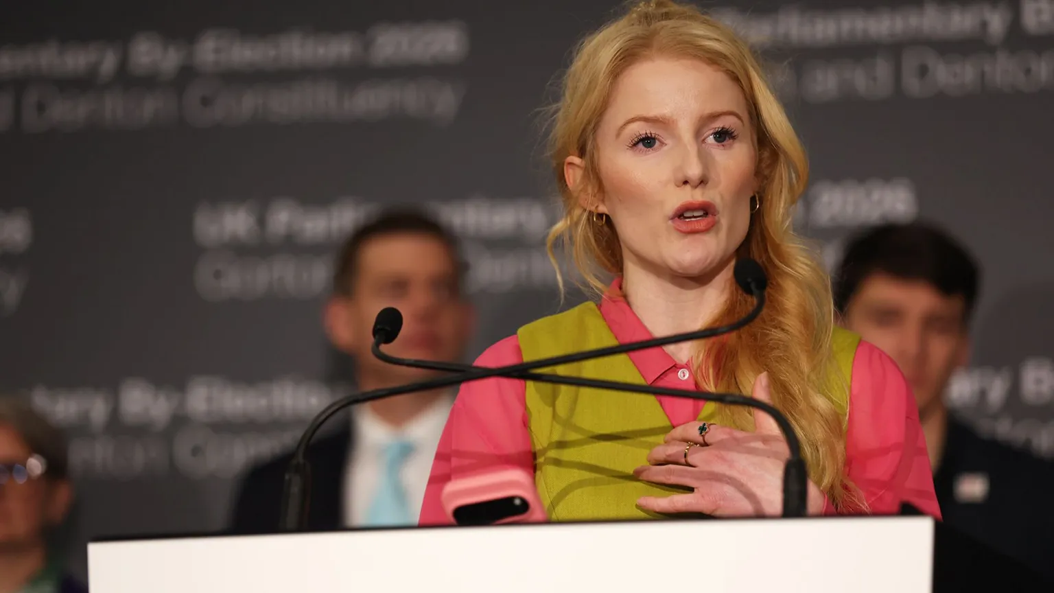 Close up of Hannah Spencer as she delivers speech after winning by-election. She is wearing pink and green.