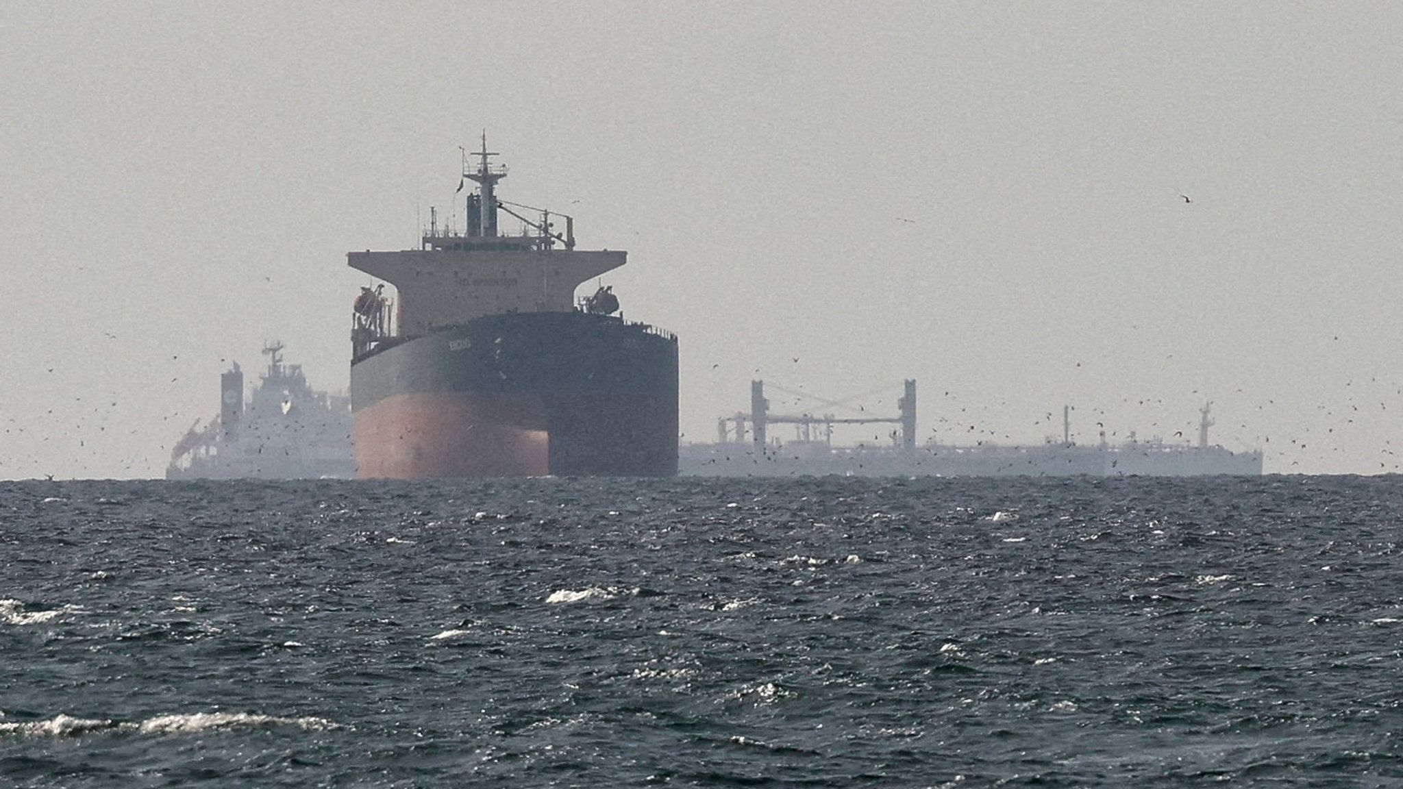 Cargo ships in the Gulf, near the Strait of Hormuz in March. Pic: Reuters