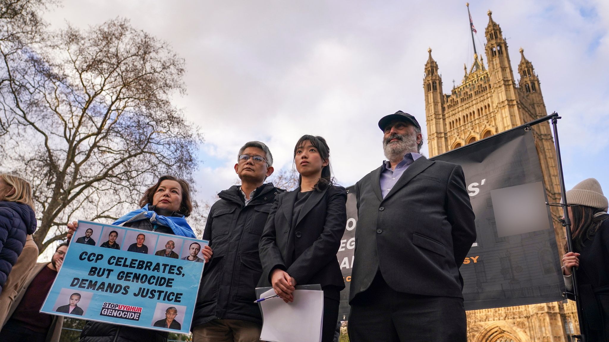 Mark Nyegate from the Royal Mint Court Residents' Association (R) protesting with Chinese dissidents in front of parliament after planning permission was granted. Pic: AP
