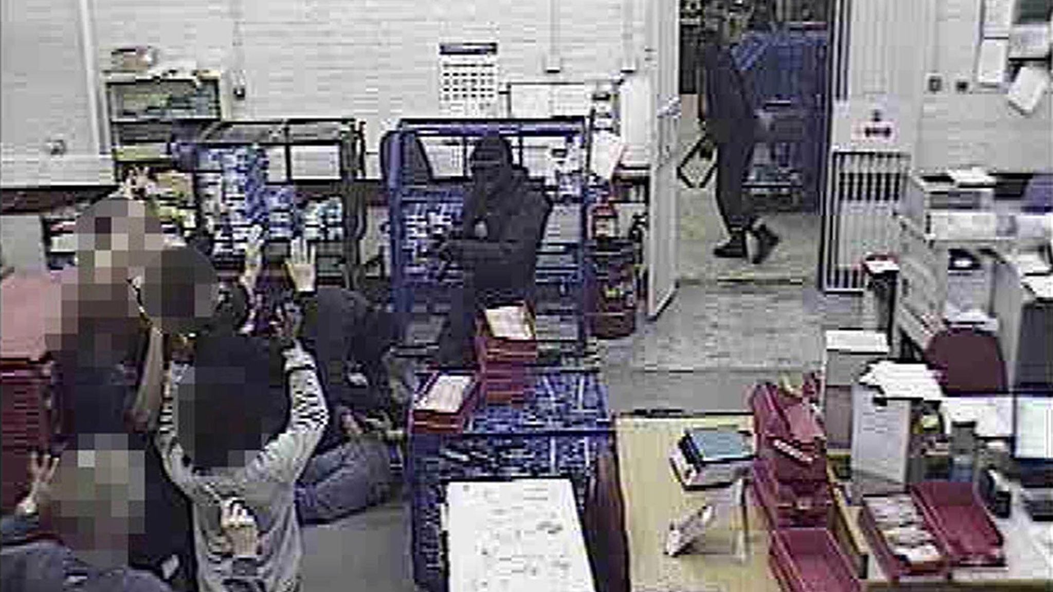 Staff held at gunpoint. Pic: PA