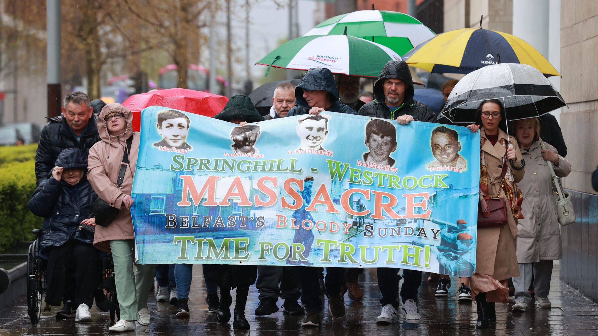Families and supporters carried a banner to Belfast Coroner's Court. Pic: PA