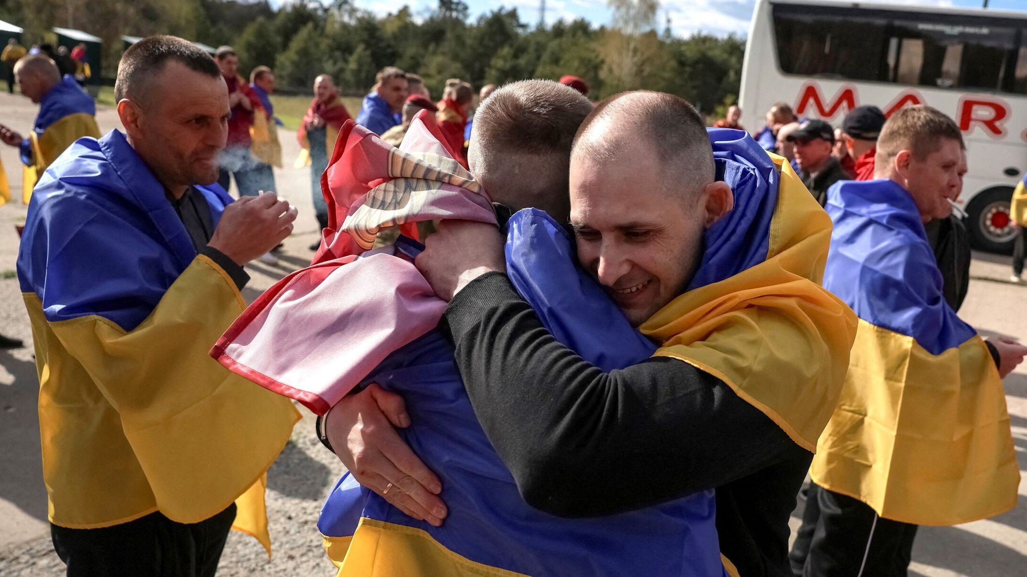 Ukrainian forces celebrate after a prisoner swap on Friday. Pic: Reuters